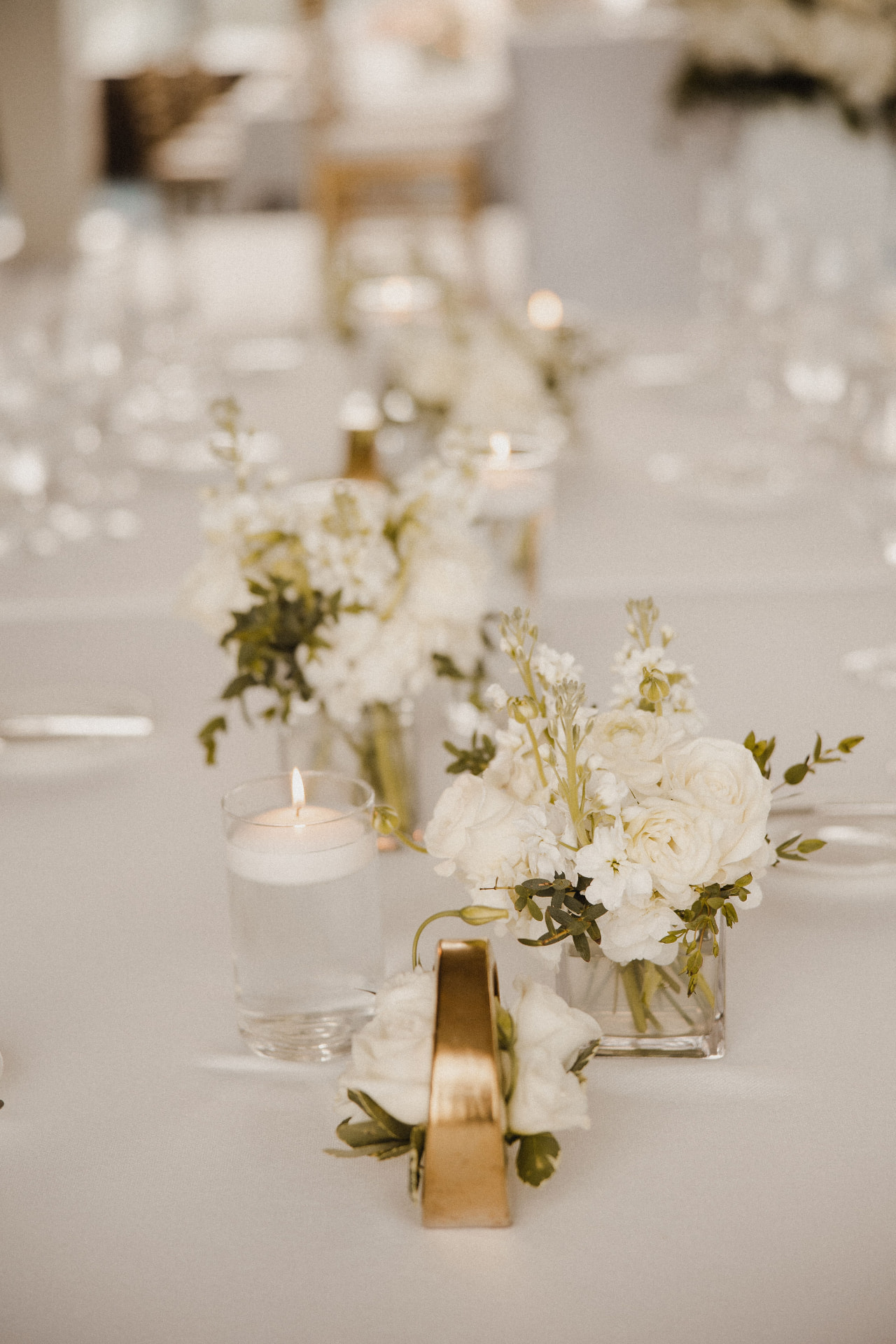 Small white arrangements with floating candles