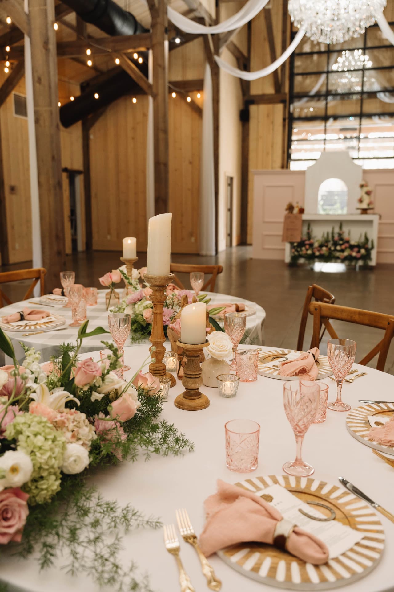 Candlelit reception tables in a barn